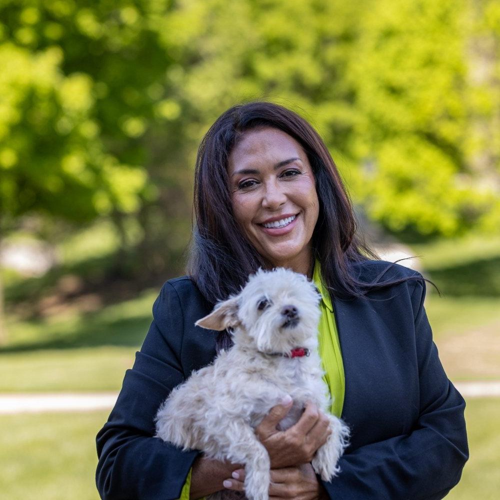 Barbara LoMonaco holding a small dog